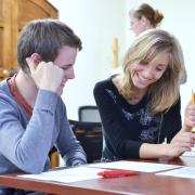 Instructor helps a student in her class