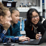 Young girls work together on computer science project