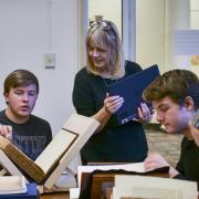 Students in HIST 1113 Honors Seminar examine rare books and pamphlets at the Norlin Library Special Collections