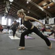 Instructor leading yoga class on campus