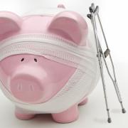 Injured piggy bank with crutches