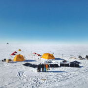 Group of researchers and tents on ice in Greenland
