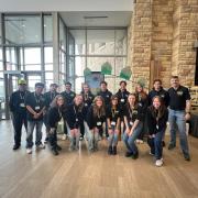 CU Boulder team poses in front of their concrete canoe