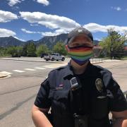 A CUPD officer wearing a Pride-themed face mask