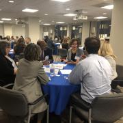 People converse at a previous Ombuds Day event.