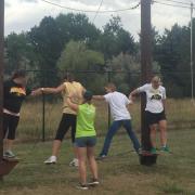 Employees participate in the UP program ropes course.