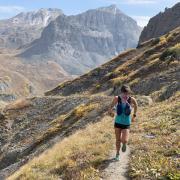 Zoe Rom running on a trail in the mountains