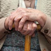 Older person holding a cane