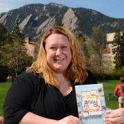 Karstee Davis holding "Eat Pray Love" book in front of the Flatirons