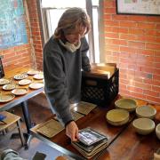 Intermediate ceramics student Katie Sieker at Café Aion packing dishes she made.