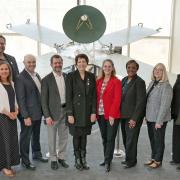 Senior NASA leaders with CU President Todd Saliman and other university officials in front of the Mariner spacecraft displayed in LASP