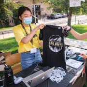Students in masks selling Sko Buffs t-shirts