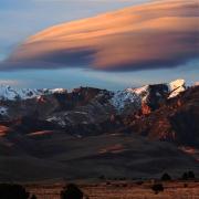 Lenticular clouds, which look a bit like a layer cake, form over Great Sand Dunes National Park in Colorado.