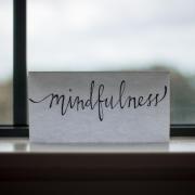 Piece of paper that says 'mindfulness' sits in a window