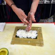 Student rolling sushi