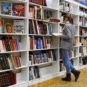 Woman peruses books at a library