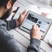 Man uses stylus pen on digital tablet screen