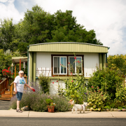 A woman walks in front of a manufactured home.