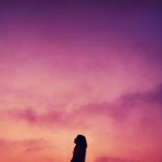 Silhouette of a person against a colorful sky