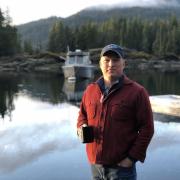 Markos Scheer in front of lake, mountains