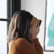 Person looks through VR goggles