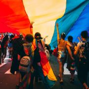 people carry giant pride flag