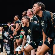 Members of the 2023 Buff Women’s Basketball Team cheer from the sideline