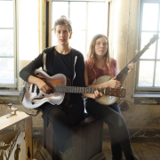 Anna & Elizabeth, musicians, pictured with instruments.