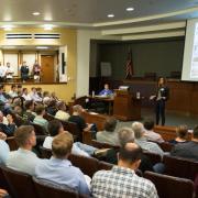 A member pitches to a crowd at a New Venture Challenge event.