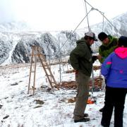 Three research collect data on a snowy Niwot Ridge.