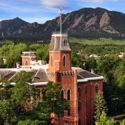 Old Main is seen against the background of the Flatirons