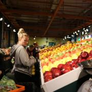 People shopping for produce in a grocery store