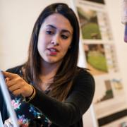 Environmental design student explains her research to a community member