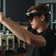 A young man appears with virtual reality glasses on.
