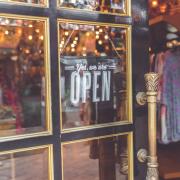 A sign on a door showing a business is open