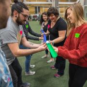 Employees participate in a group activity during a wellness session on campus