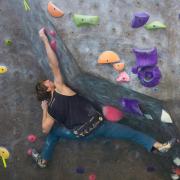 A man climb the Rec Center rock wall