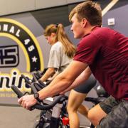 Students riding stationary bikes in a campus rec center