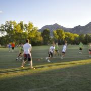 Students playing intramural football at CU Boulder