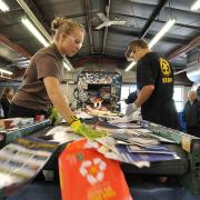 Students sort through recycled material in the Recycling Center at CU Boulder