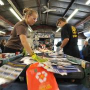 students sorting through recycled goods at the recycling center on campus