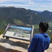 Two people overlook scenery at Rocky Mountain National Park