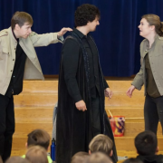 Actors in the Shakespeare and Violence Prevention project act out a scene in front of students.