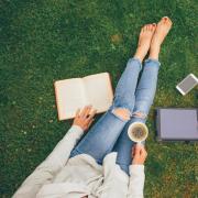 Person reading book and drinking coffee