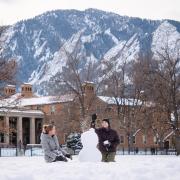 Students build a snowman on campus