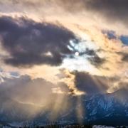 Sunrays shine through clouds from a view on East Campus