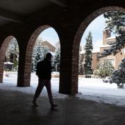 Student walking on snowy campus