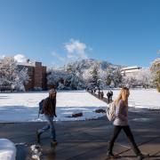 students walking across a snowy campus