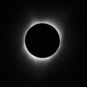 Image of the sun fringed in white light as seen during an eclipse