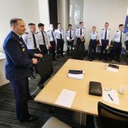 Air Force ROTC cadets line up in a conference room during a meeting with Brig. Ge. John Olson